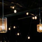 Close-up of decorative hanging light bulbs illuminating a dark interior space.
